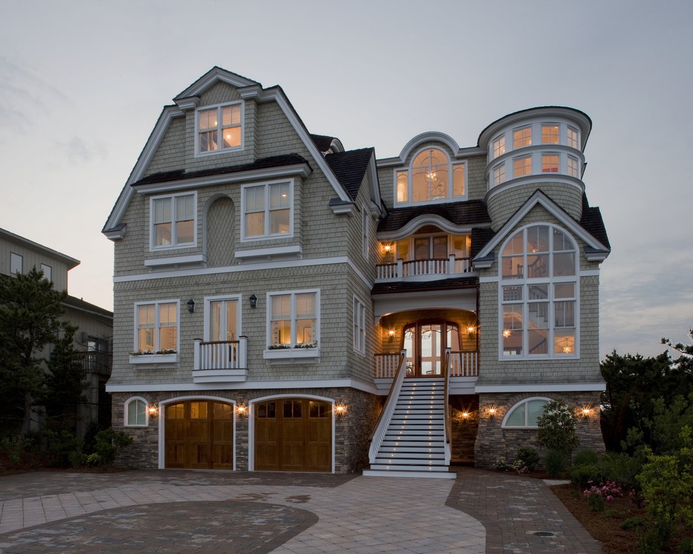 Design ideas for a large nautical house exterior in Philadelphia with three floors and wood cladding.
