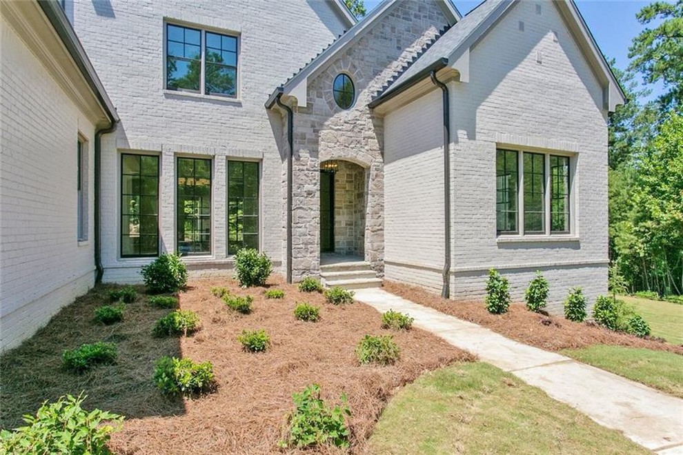 Large transitional gray two-story brick exterior home idea in Atlanta with a shingle roof