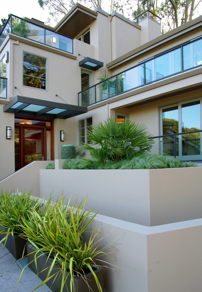 Example of a trendy beige three-story exterior home design in San Francisco