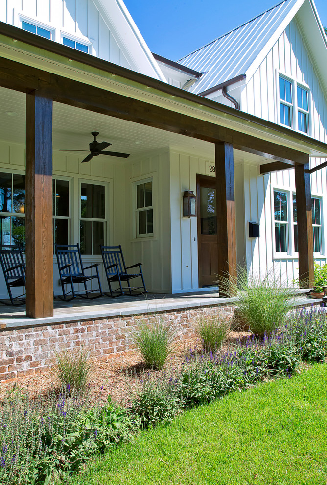 Mid-sized country white two-story concrete fiberboard exterior home photo in Raleigh with a metal roof