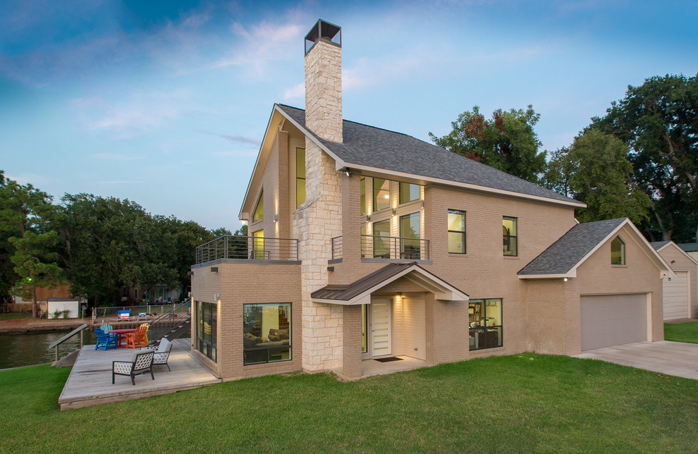 Photo of a modern two floor brick detached house in Dallas with a shingle roof.