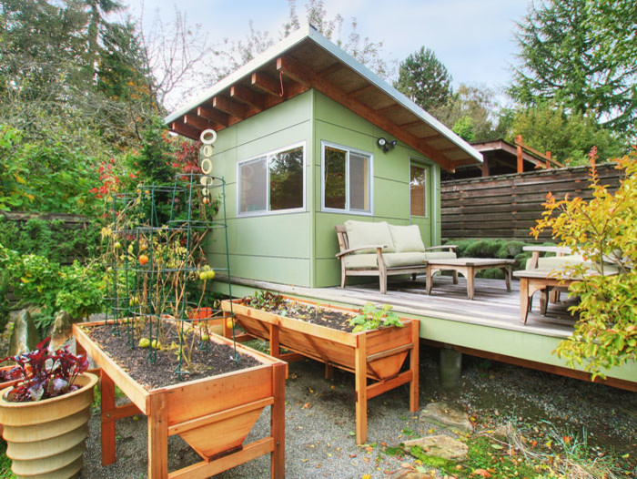 Diseño de fachada de casa verde de estilo americano pequeña de una planta con tejado de un solo tendido