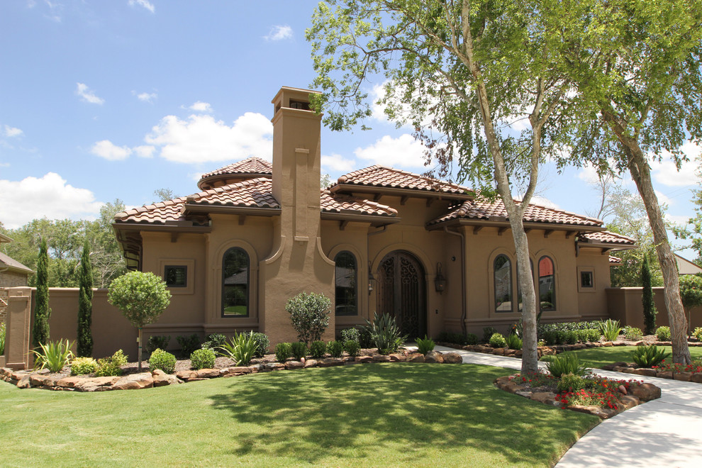 Large and brown mediterranean bungalow render house exterior in Houston.