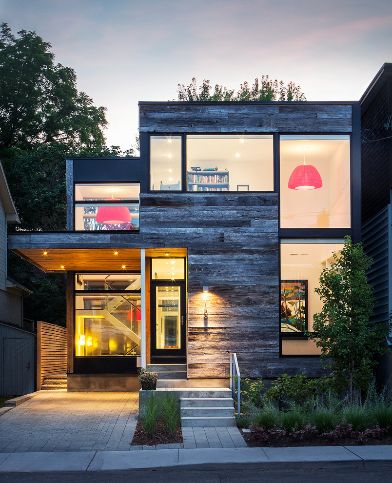 Photo of a contemporary house exterior in Ottawa with wood cladding.