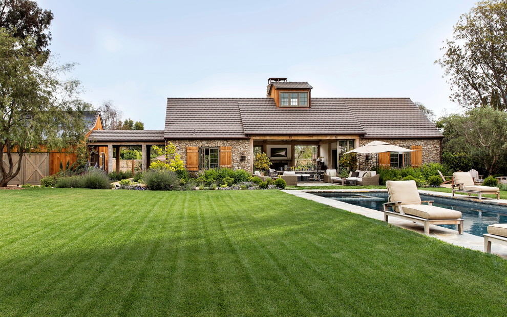 Großes, Einstöckiges Country Einfamilienhaus mit Steinfassade, grauer Fassadenfarbe, Schindeldach und Satteldach in Los Angeles