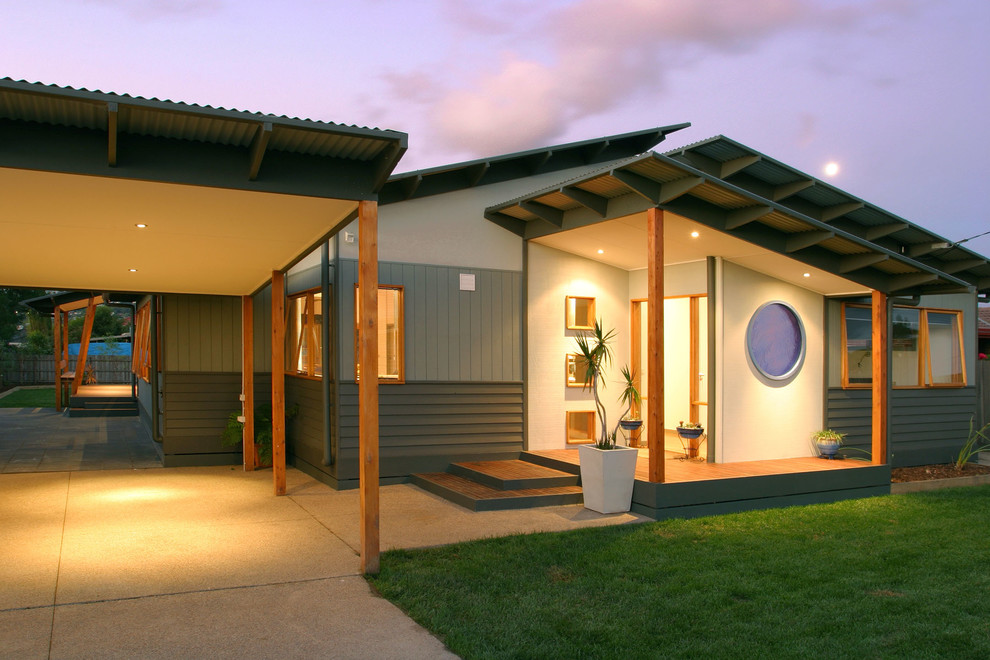 Large trendy green one-story vinyl house exterior photo in Melbourne with a shed roof and a metal roof