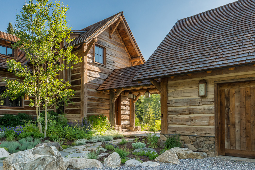 Inspiration for a rustic two floor house exterior in Philadelphia with wood cladding.
