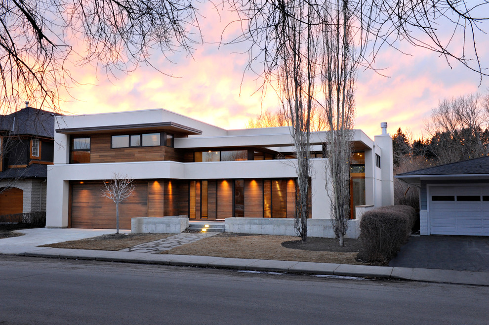 Inspiration for a large modern brown two-story wood flat roof remodel in Calgary