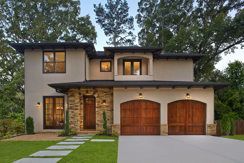 This is an example of a medium sized and beige mediterranean two floor house exterior in Atlanta with mixed cladding.