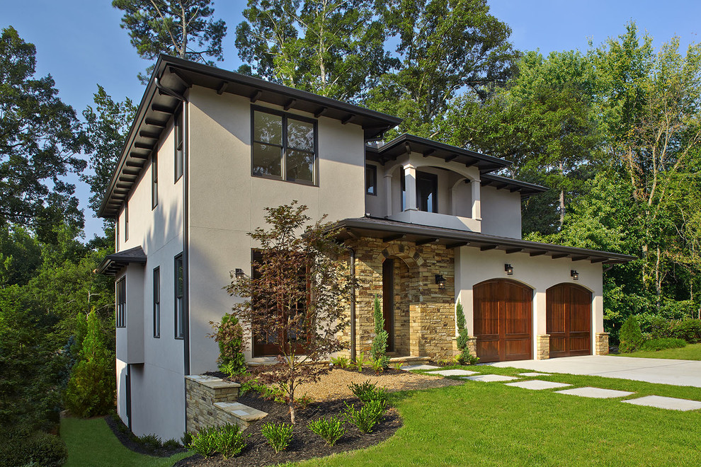 Photo of a beige mediterranean two floor house exterior in Atlanta with mixed cladding.