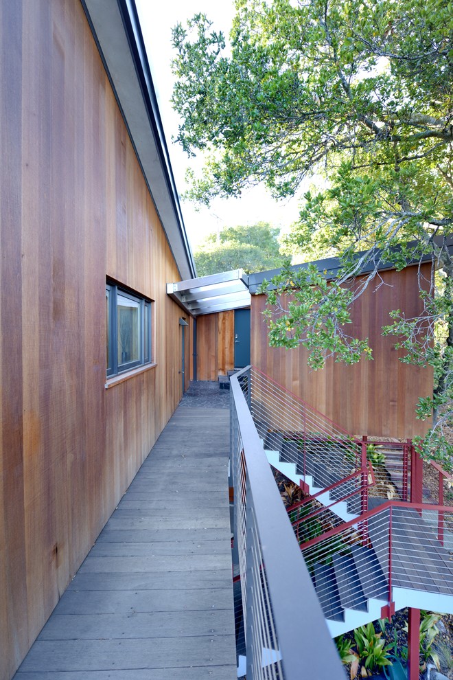 Inspiration for a large modern brown two-story wood exterior home remodel in San Francisco with a metal roof and a gray roof