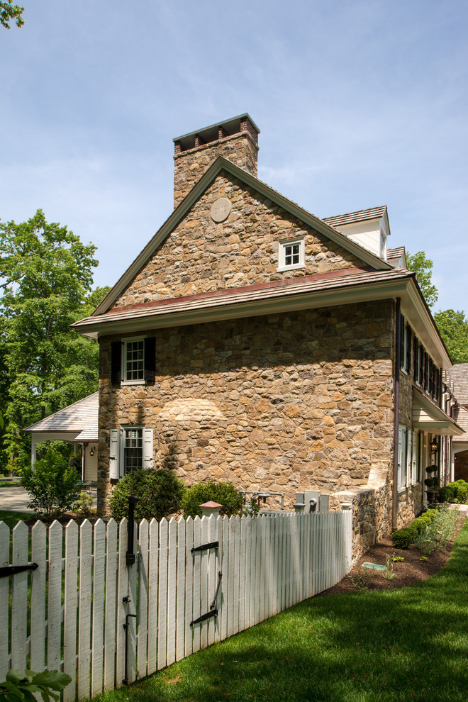 Classic house exterior in Philadelphia with three floors, stone cladding and a pitched roof.