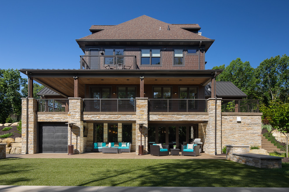 Exemple d'une très grande façade de maison marron moderne en bois à un étage avec un toit à deux pans et un toit en shingle.