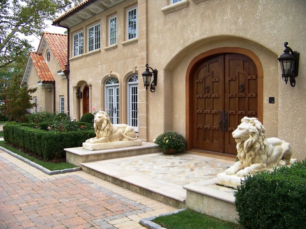 Mediterranean beige three-story adobe house exterior idea in New York with a gambrel roof and a tile roof