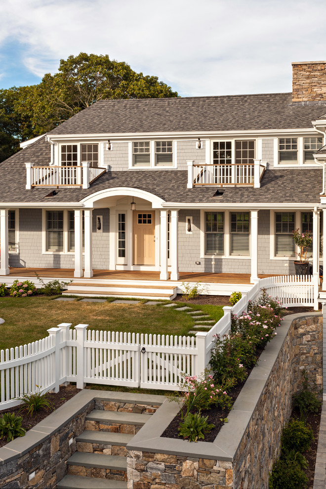 Photo of a large and gey coastal house exterior in Boston with a hip roof.
