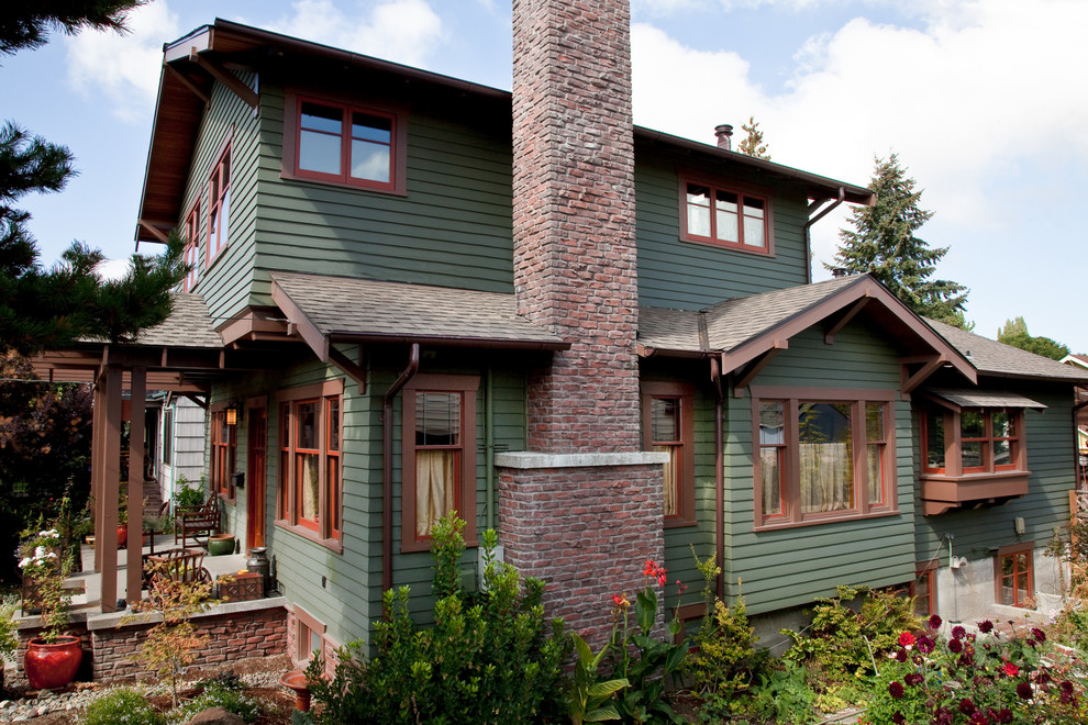 Mid-sized traditional green two-story wood gable roof idea in Seattle