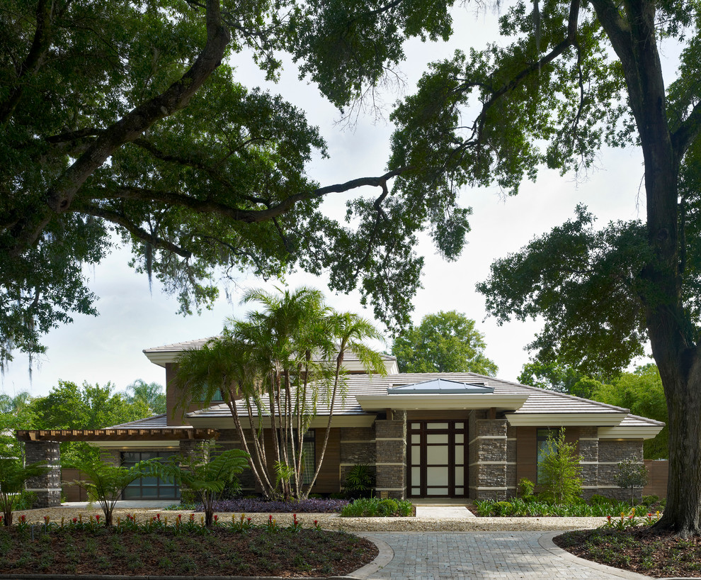 Brown classic two floor house exterior in Orlando with mixed cladding and a hip roof.