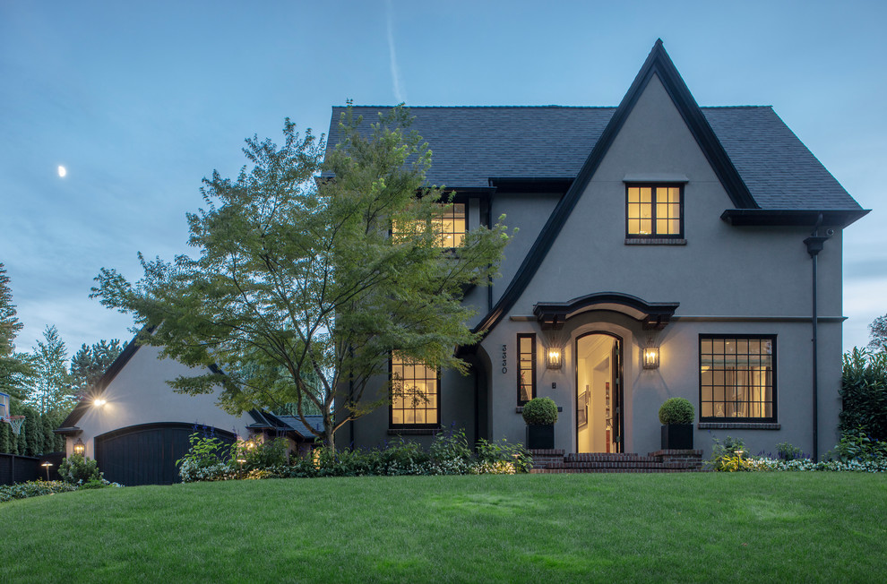 Inspiration for a timeless beige stucco exterior home remodel in Portland with a shingle roof