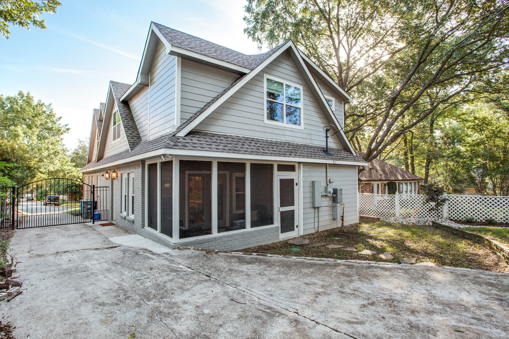 Mid-sized traditional gray two-story brick gable roof idea in Dallas