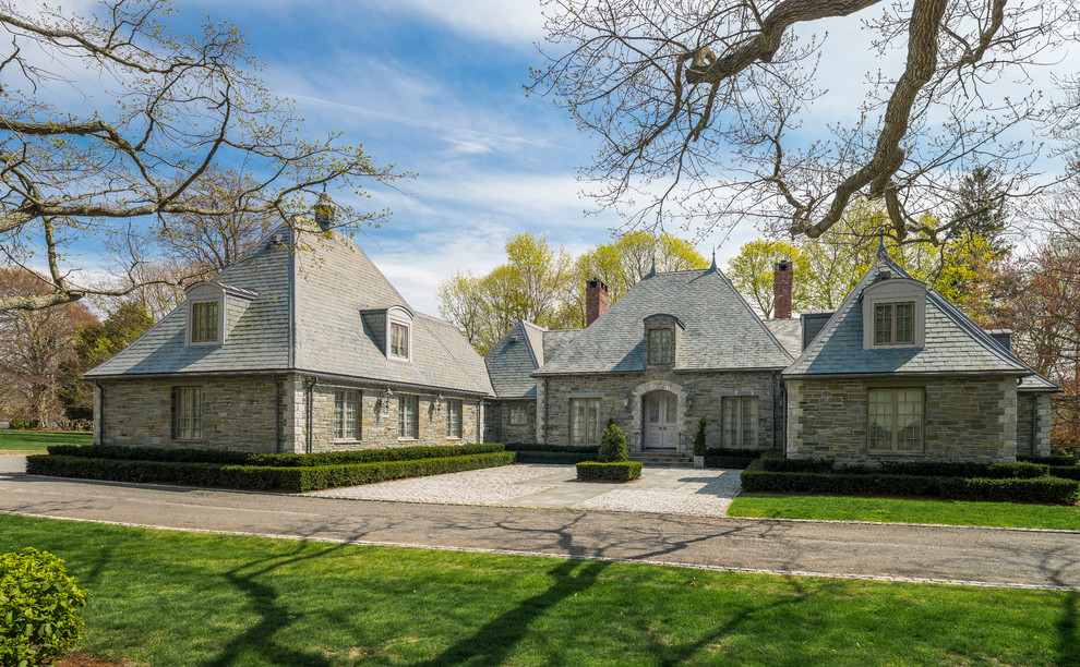 Example of a large classic two-story stone exterior home design in Providence with a hip roof