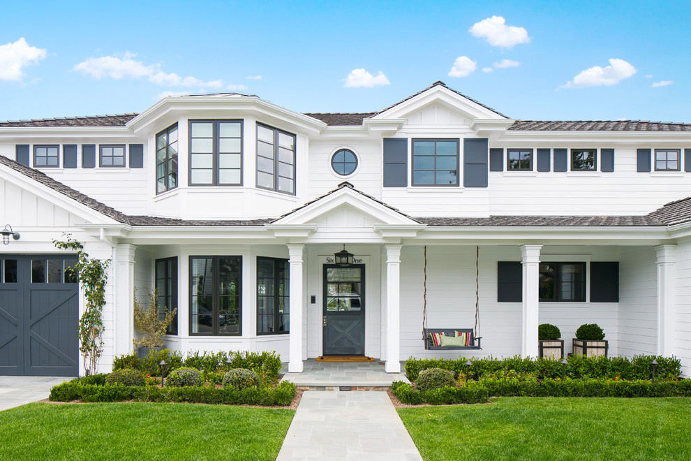 Design ideas for a white nautical two floor house exterior in Orange County.