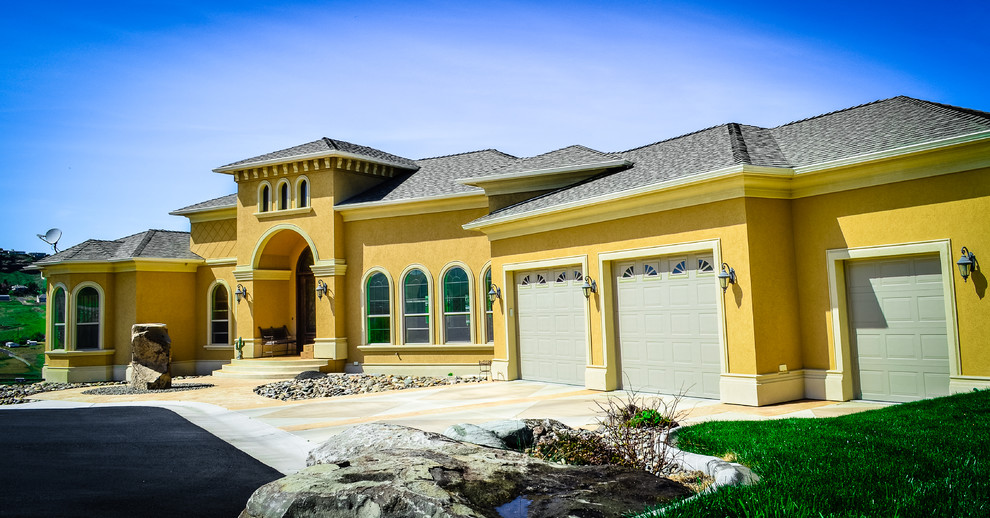Large and yellow mediterranean two floor render house exterior in Boise.