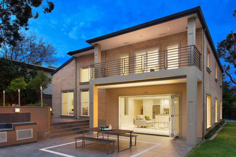 Inspiration for a beige contemporary two floor brick house exterior in Sydney with a flat roof.