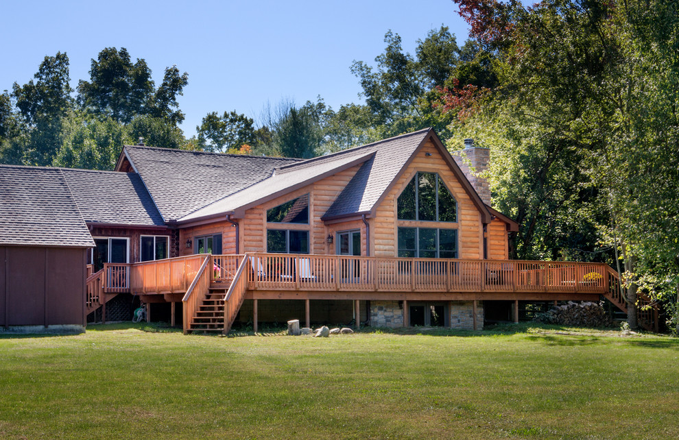 This is an example of a large and brown rustic bungalow house exterior in Columbus with wood cladding and a hip roof.