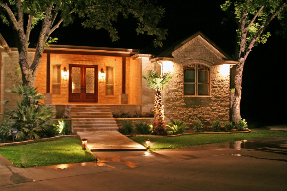 Example of a mid-sized classic beige one-story stone exterior home design in Austin