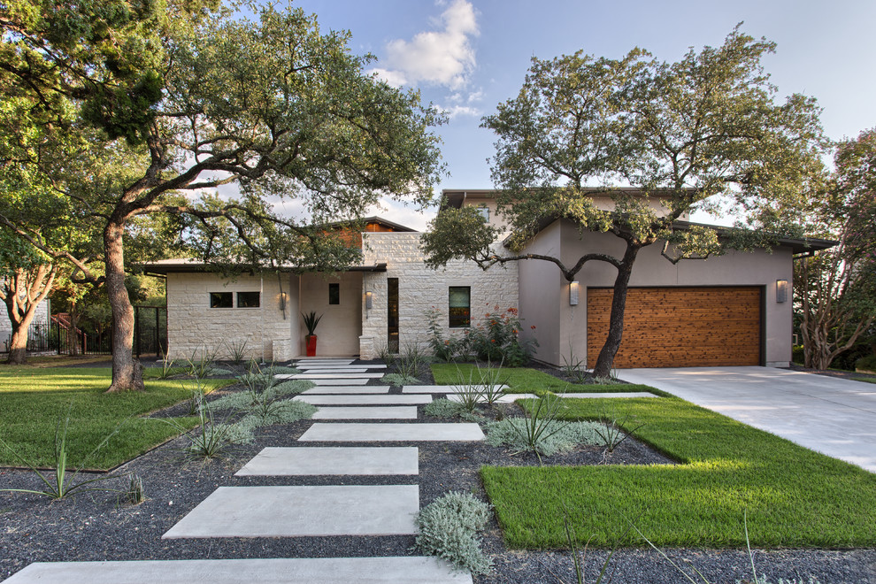 Contemporary house exterior in Austin with stone cladding and a lean-to roof.