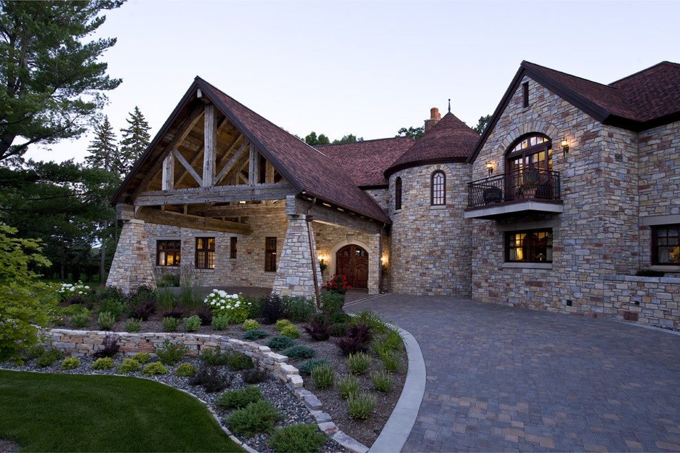 Inspiration for a rustic two-story stone exterior home remodel in Minneapolis
