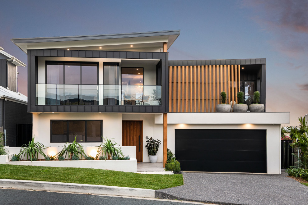 Large contemporary black two-story mixed siding exterior home idea in Wollongong with a metal roof