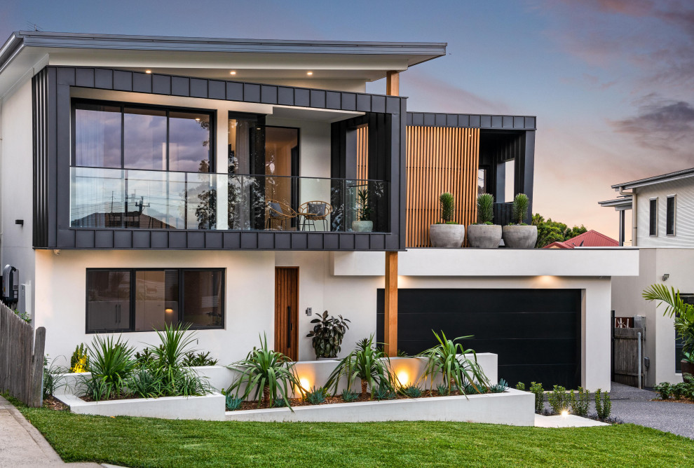 Inspiration for a large contemporary black two-story mixed siding exterior home remodel in Wollongong with a metal roof