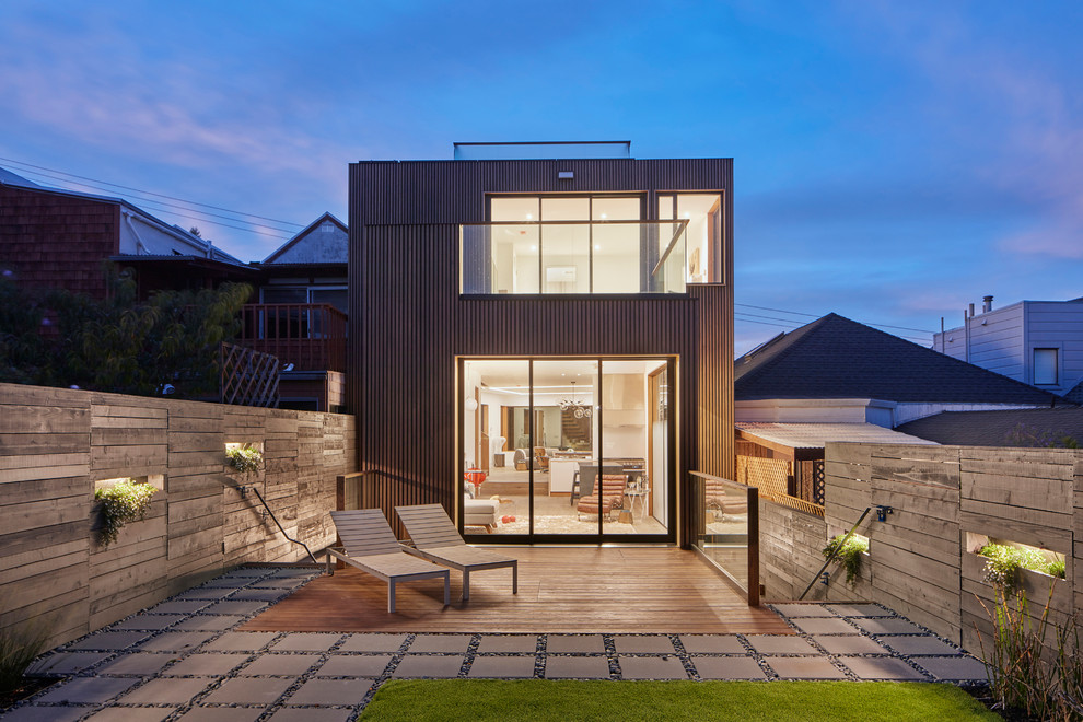 This is an example of a medium sized contemporary detached house in San Francisco with three floors, wood cladding and a flat roof.