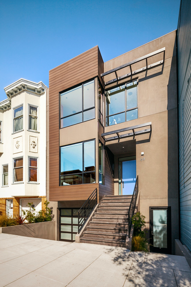 This is an example of a medium sized and brown contemporary house exterior in San Francisco with three floors, mixed cladding and a flat roof.