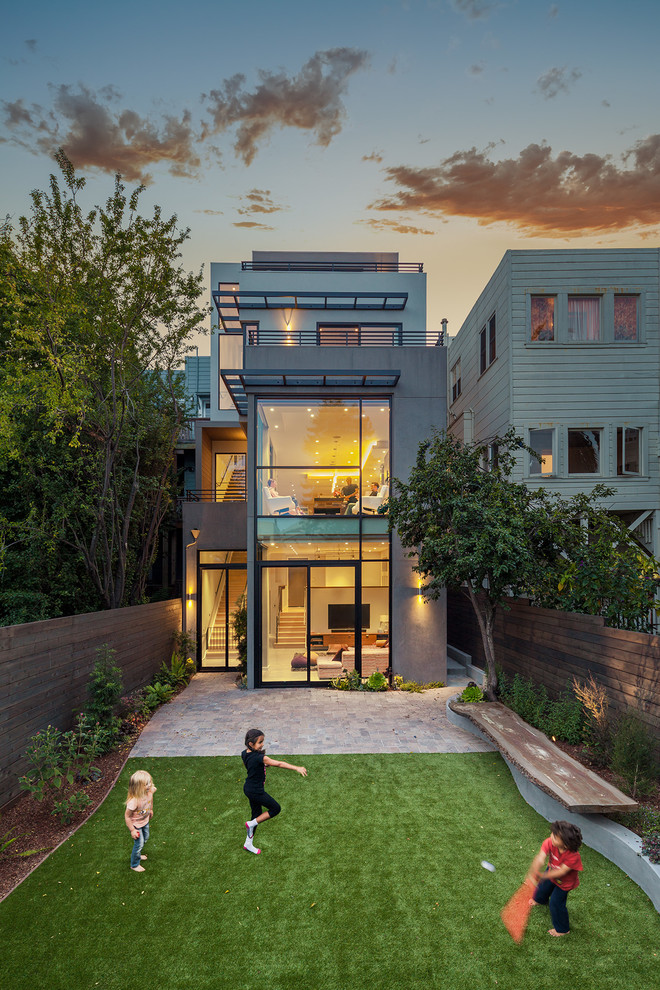 Inspiration for a large contemporary house exterior in San Francisco with three floors and a flat roof.