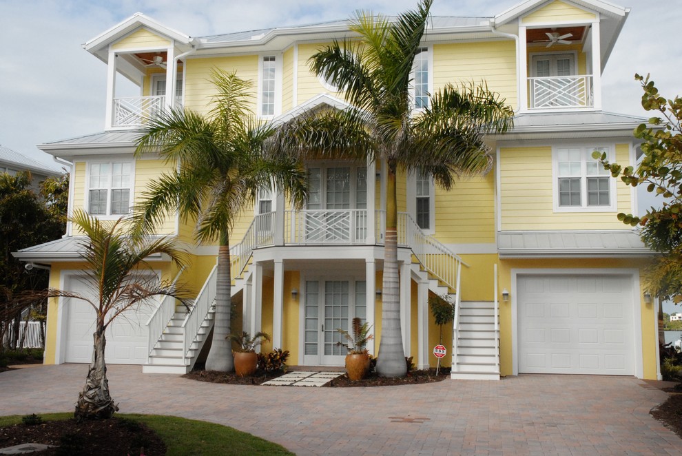 This is an example of a beach style house exterior in Tampa with three floors.