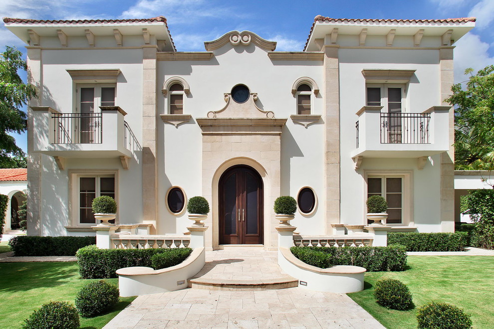 Mediterranean white two-story exterior home idea in Other