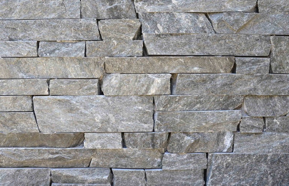 Inspiration for a gey contemporary house exterior in Houston with stone cladding.