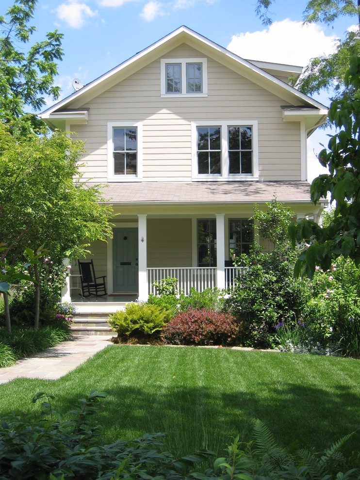 Photo of a beige and medium sized classic two floor house exterior in DC Metro with wood cladding and a pitched roof.