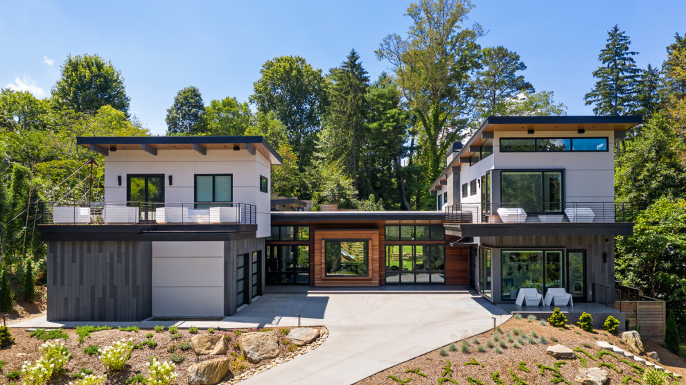 Großes, Zweistöckiges Modernes Einfamilienhaus mit Mix-Fassade, bunter Fassadenfarbe, Pultdach und Misch-Dachdeckung in Sonstige