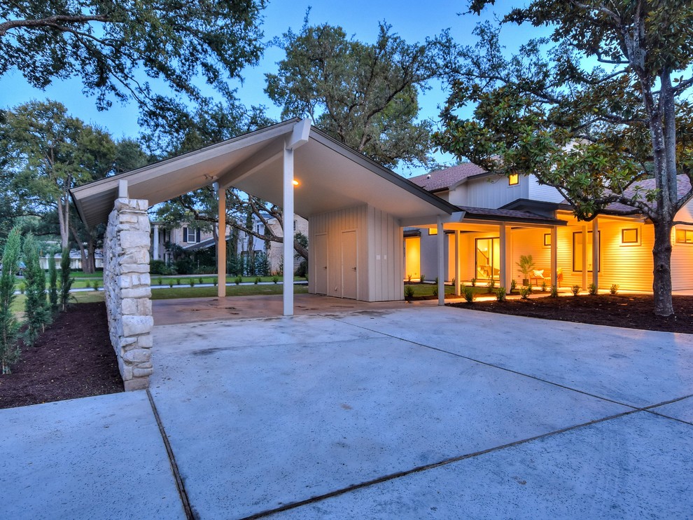 Large transitional white two-story mixed siding exterior home photo in Austin with a shed roof