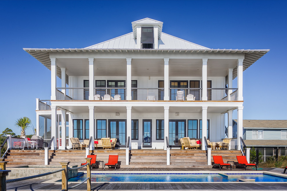 Coastal white two-story exterior home idea in Charleston with a hip roof
