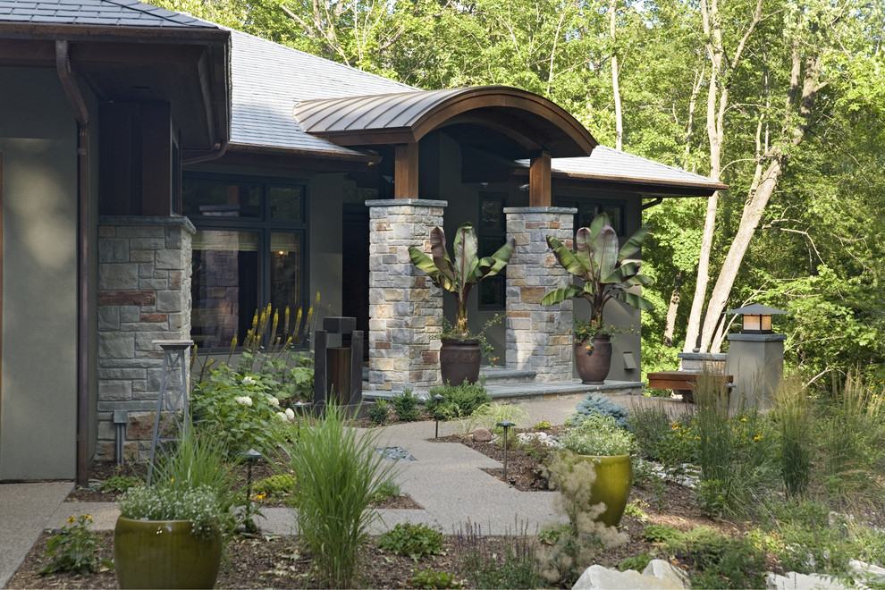 Inspiration for a large contemporary green one-story stucco exterior home remodel in Minneapolis