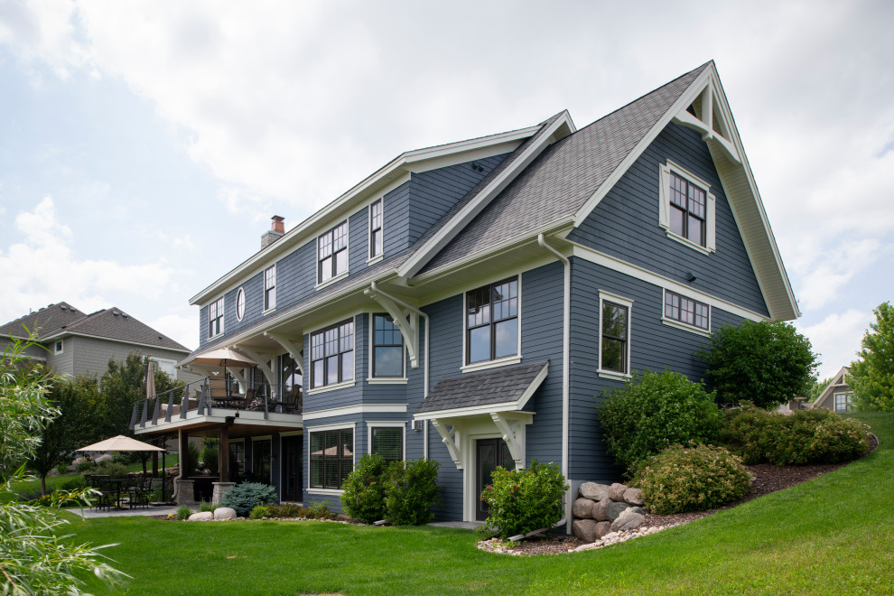 Example of a large transitional blue two-story exterior home design in Minneapolis with a shingle roof