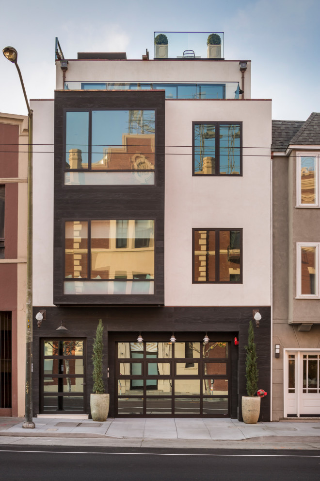 Immagine della facciata di un appartamento grande multicolore contemporaneo a tre piani con tetto piano e rivestimento in adobe