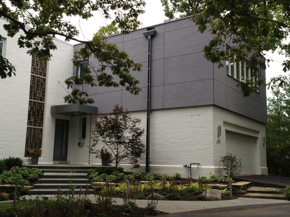 Example of a mid-sized minimalist gray two-story concrete fiberboard flat roof design in Chicago