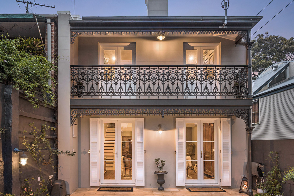 This is an example of a gey classic two floor detached house in Sydney.