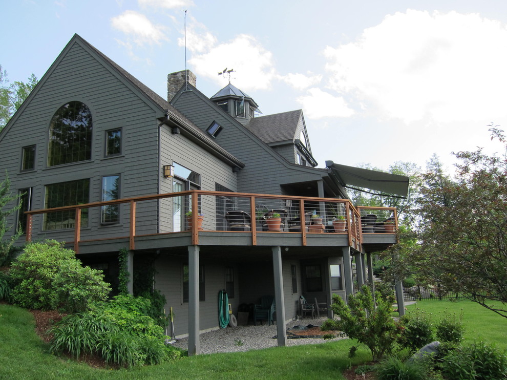 Large elegant gray two-story wood exterior home photo in Boston with a shingle roof