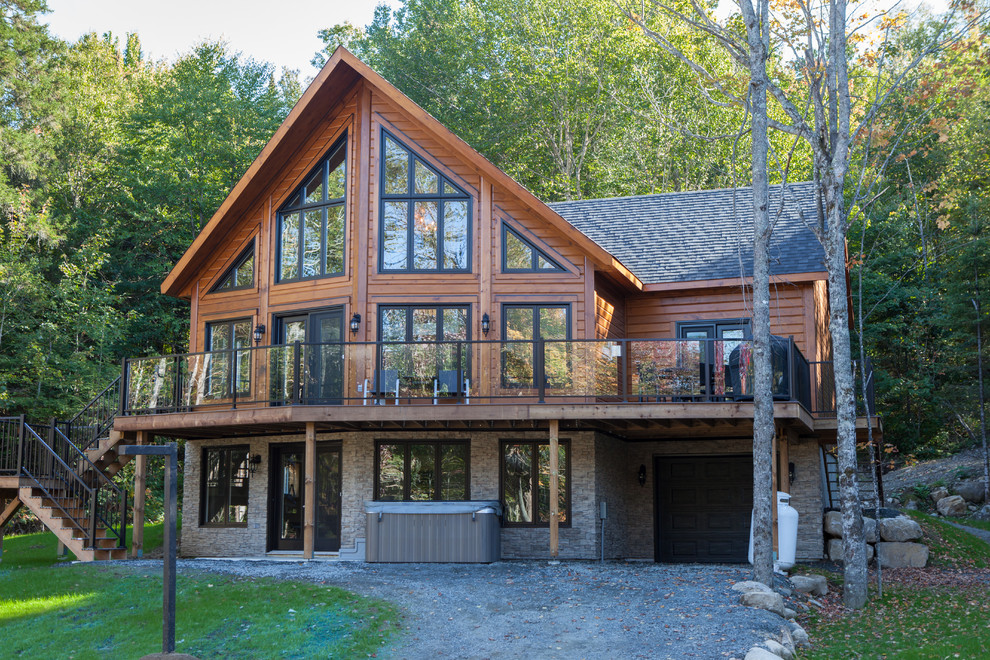 Idée de décoration pour une façade de maison marron chalet en bois de taille moyenne et à deux étages et plus.